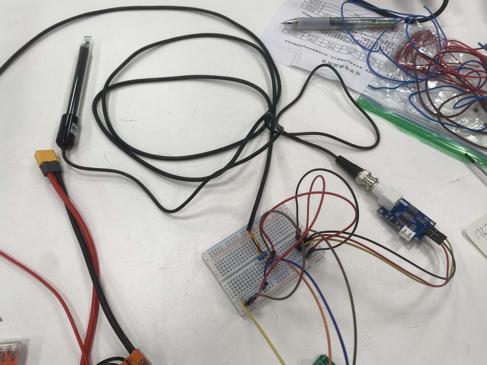 Waterproof DS18B20 temperature probe and the EC conductivity probe wired to the breadboard for calibration