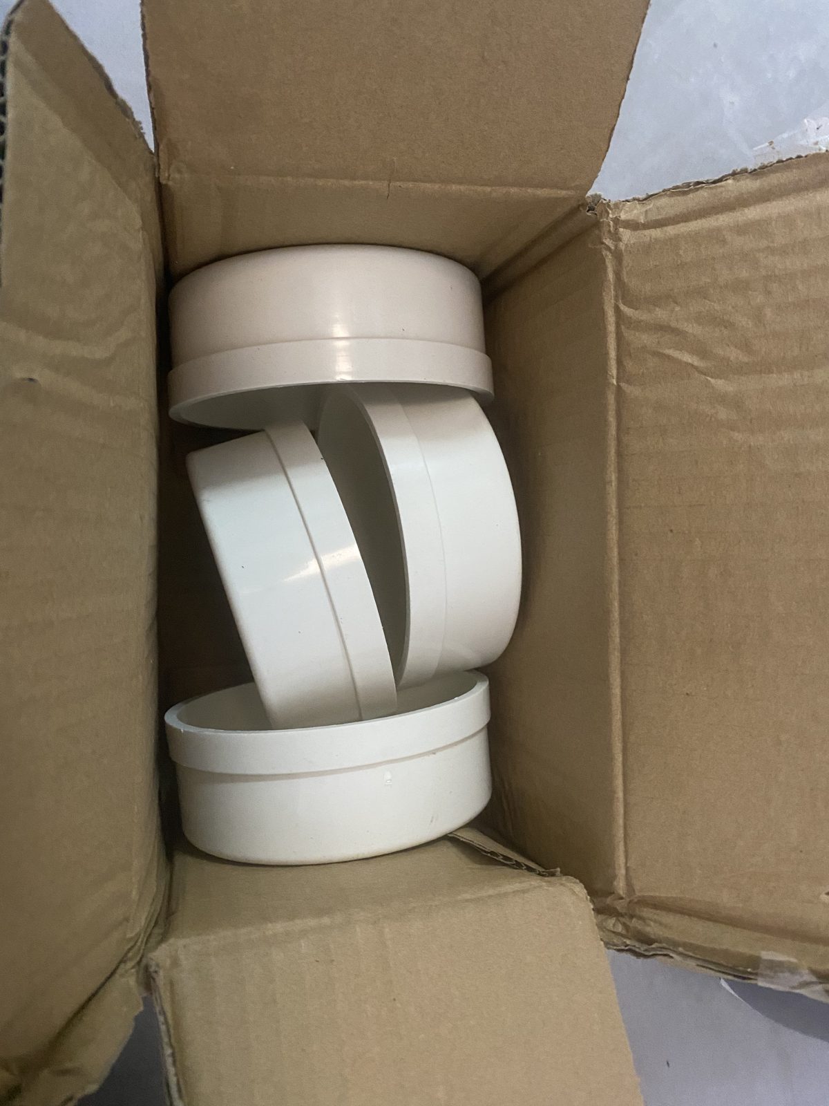 PVC pipe couplings and end caps as delivered in their shipping box